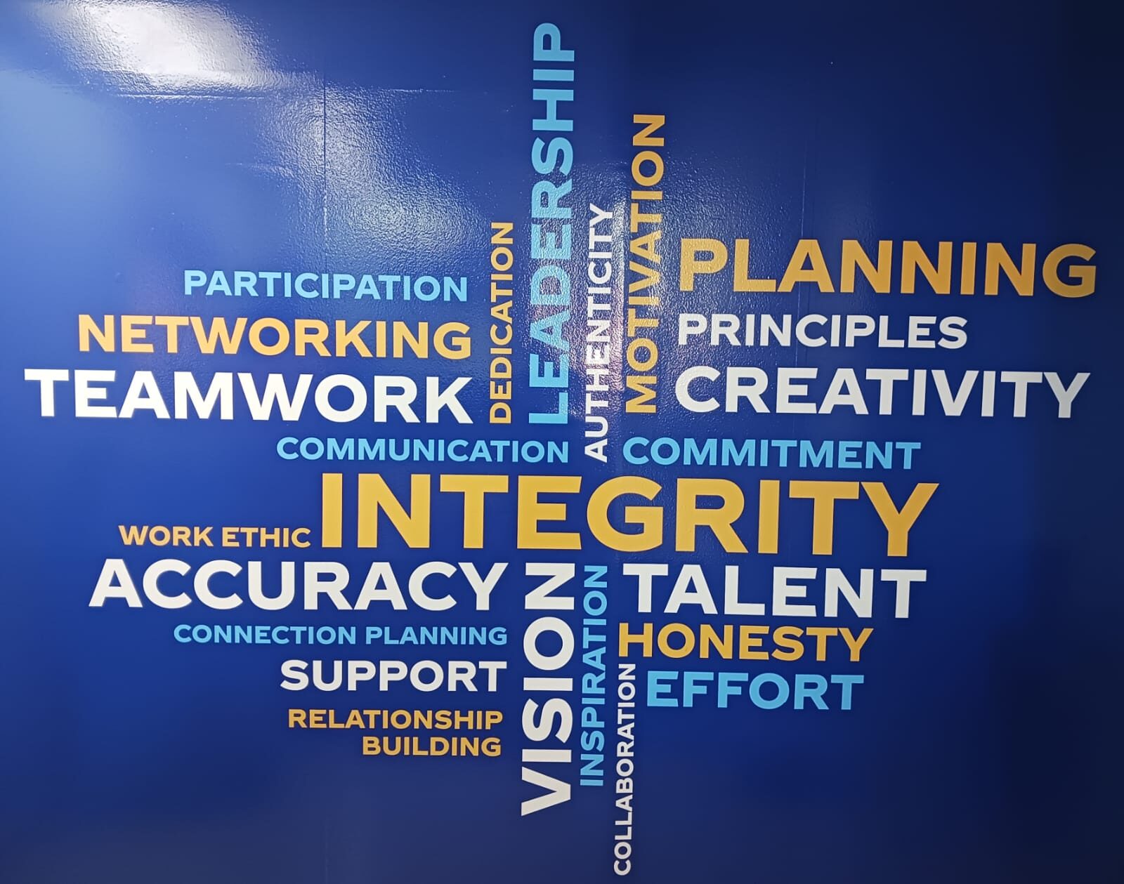 E-Max core values wall: integrity, teamwork, accuracy, honesty, and planning